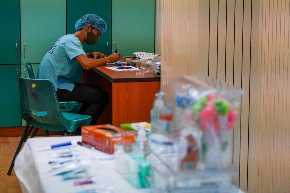 Dr Lim documenting the data collected after the dental screening. (Photo by Chan May Ching)